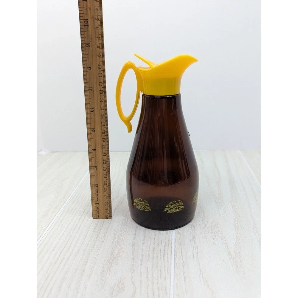 Log Cabin vintage syrup dispenser pitcher amber glass yellow lid patriotic eagle